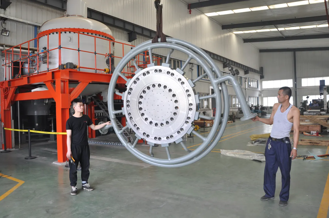 Large pelletizing die plate in a lifting fixture in front of the JINFENG vacuum brazing furnace