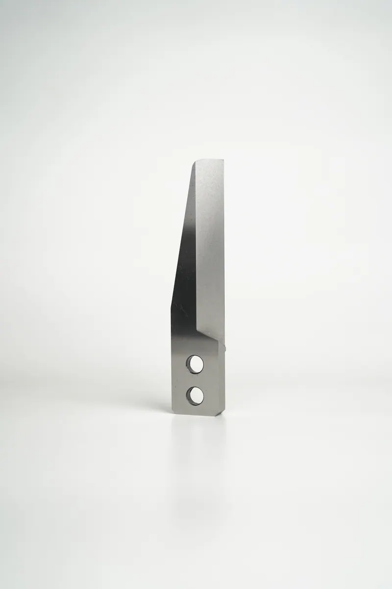 Machined pelletizer knife on a neutral background